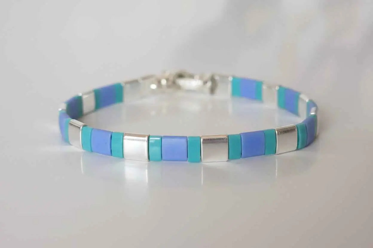 Azure Pulse Tila Bracelet by Gem N Glow features vibrant blue beads and intricate design for stylish wristwear.