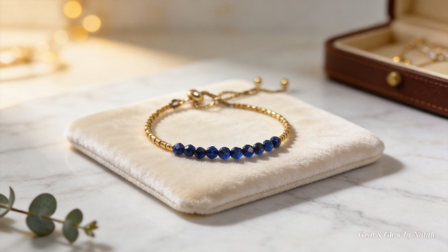 Handmade lapis lazuli bracelet with gold-tone details displayed on a soft jewelry pouch by Gem N Glow by Natali