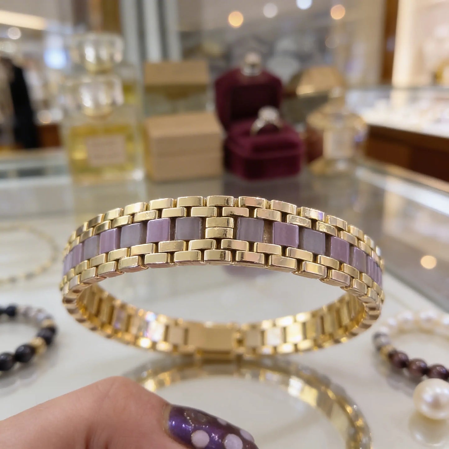 Close-up of handmade Miyuki Tila and Half Tila bracelet in blush pink soft grey and gold tones