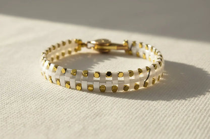 Handcrafted white and gold Miyuki bracelet with modern minimalist styling from the Metal Motion collection by Gem & Glow by Natali.